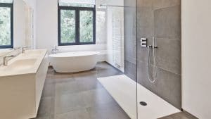 Bathroom with brown stone tile and white bathtub